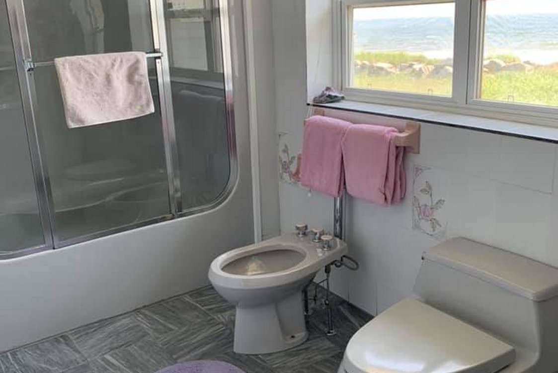View of the beach, through the large SeaSpray Suite 4 pc Bathroom