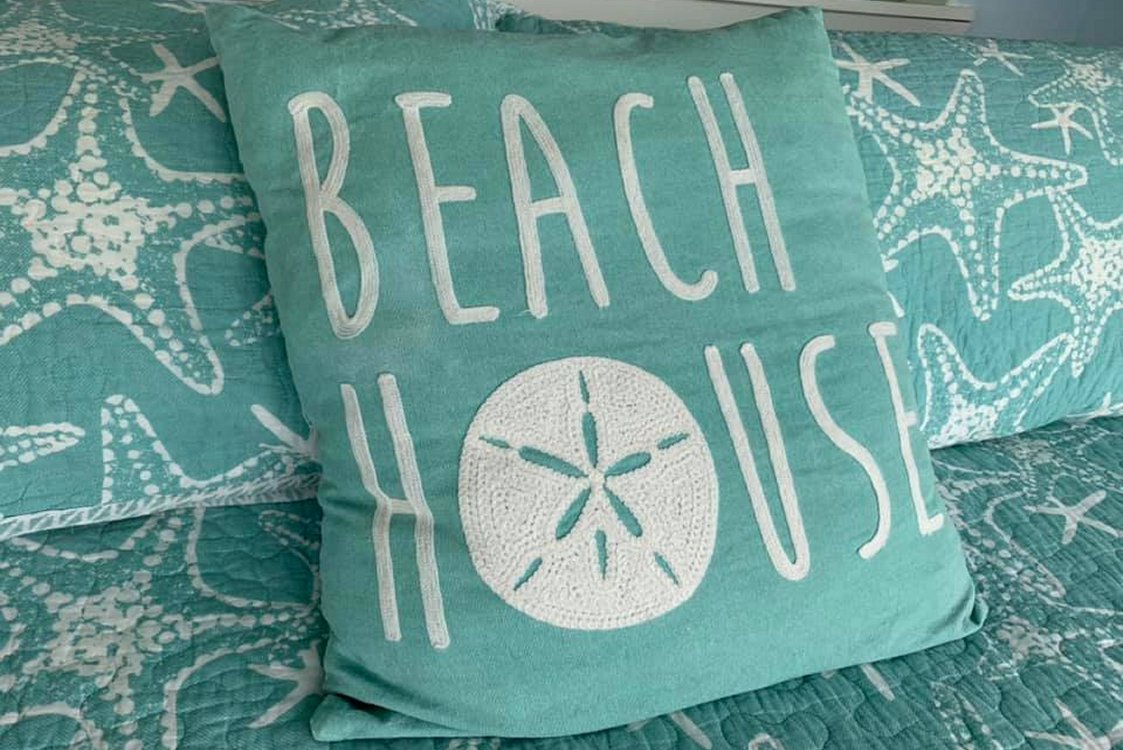 Sea Spray suite bedroom - sleep by the beach pillow