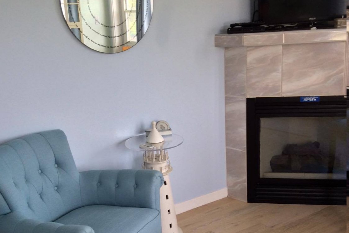 Cozy corner fireplace in the combined bed-sitting room and seating